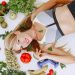 Woman lying with fresh vegetables promoting healthy lifestyle.